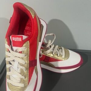 Big Kids Red , white and gold Puma Sneakers. New without the box. Size 7.